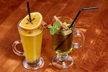 Two glasses of mulled wine with orange, cinnamon sticks