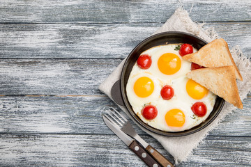 breakfast with eggs, cherry tomatoes, bacon and fresh toasted toast