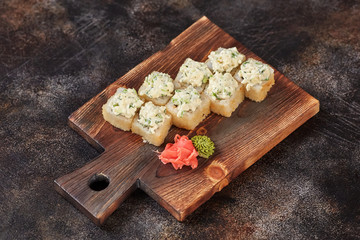Obraz na płótnie Canvas Japanese food sushi maki rolls on wooden board
