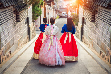 Fototapeta premium Korean lady in Hanbok walk in an ancient town