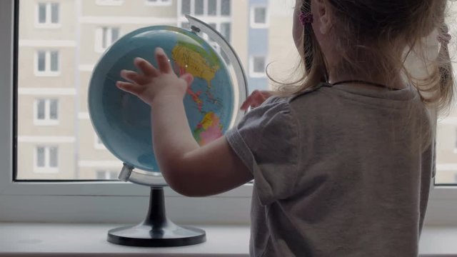 Girl looking at the globe