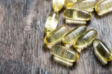 Fish oil capsules with omega 3 and vitamin D. healthy and diet concept.