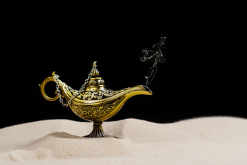 Aladdin magic lamp on the sand