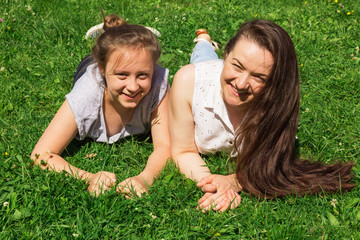 Fototapeta premium Two beautiful girls have fun on city park. Copy space.