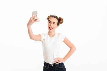 Portrait of a pretty casual girl taking selfie