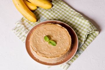 Banana cream pie on a white plate