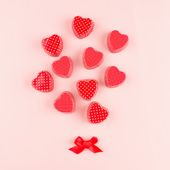 Abstract bouquet of red hearts on soft pink color background, valentine card. Valentine day  backdrop.