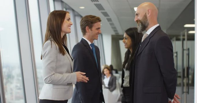 4K Portrait young smiling businesswoman talking with colleagues in modern office. Slow motion