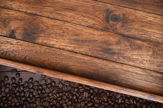 close up of coffee beans on wooden background