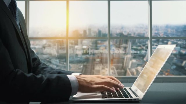 View of Shenyang China.Close up hand Businessman using laptop