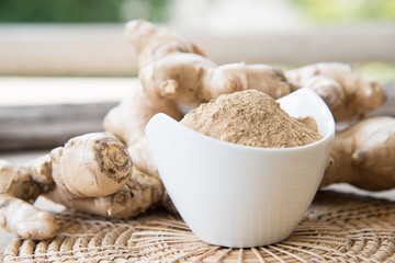 Fresh ginger on wood texture.