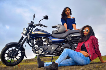 Plakat Young Indian girls posing on motorcycle, Pune