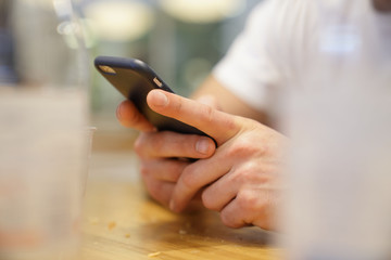 Closeup of man's hands and smartphone