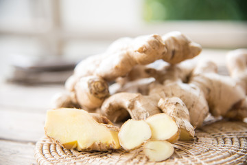 Fresh ginger on wood texture.