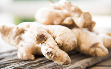 Fresh ginger on wood texture.