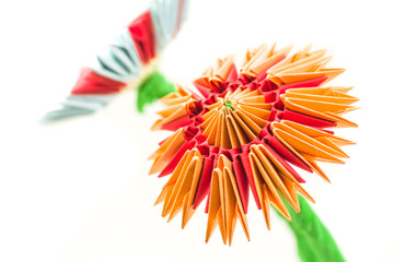 bright modular origami orange and red flower isolated on white background