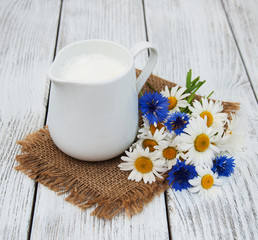 jug with milk  and wildflower