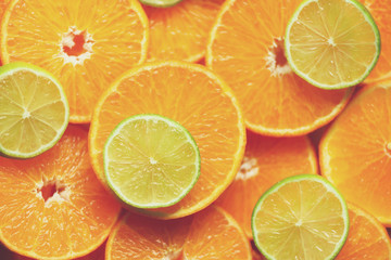 Fresh sliced orange fruit texture. Macro, top view, copy space. Food frame. Juicy oranges and lime background