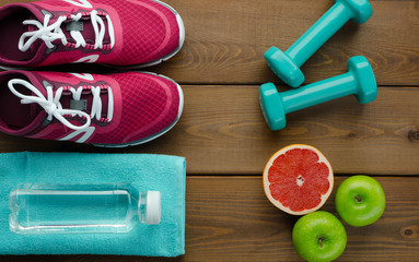  sneakers dumbbells bottle of water apple pomelo and measure tape