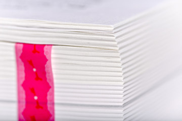 A thick book with a pink bookmark close up. 