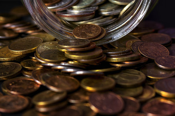 Coins poured from the glass jar.