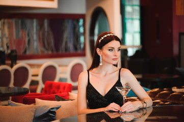 Portrait of beautiful woman holding glass of martini