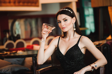 Portrait of beautiful woman holding glass of martini