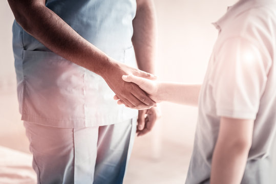 Nice To Meet You. Scaled Up Look On A Male Doctor And A Preteen Boy Shaking Their Hands Together While Meeting For The First Time At Clinic.