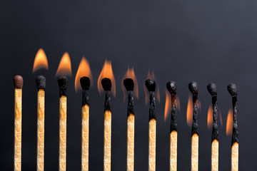 Set of burning match isolated on dark background.