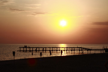 Fototapeta na wymiar Old pier on the background of summer sunset on the Black sea