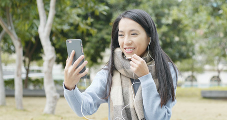 Woman making a video call on cellphone at outdoor