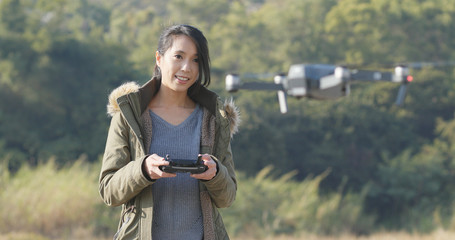 Woman control flying drone at outdoor