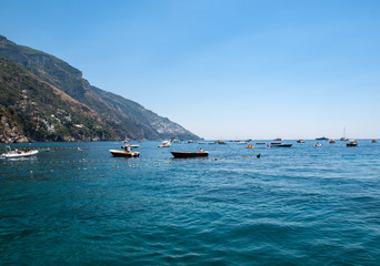  Fishing boats and yachts moored in Tyrrhenian Sea near Positano, Amalfi Coast. Italy