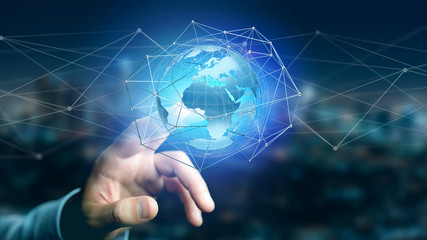 Businessman holding a Connected network over a earth globe concept on a futuristic interface - 3d rendering