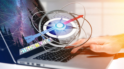 Business man using a navigation compass on a laptop - 3d rendered