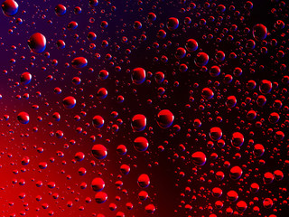 Water droplets on a dark red background and blue highlights 