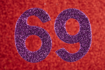 Number sixty-nine purple color over a red background. Anniversary