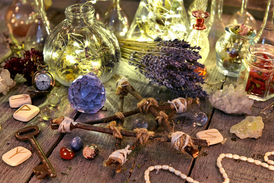 Magic ritual collection with bottles, lavender flowers, pentagram, runes and crystals. Occult, esoteric, divination and wicca concept. Halloween background with vintage objects 