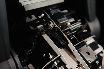 The lighting engineer repairs the light device on stage