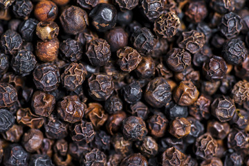 Black peppercorns as a texture close up.