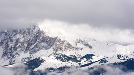 Fototapeta na wymiar Dolomites. Winter views in the fog and low clouds