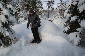 Fototapeta na wymiar Campfire in deep snow, preparation, man tread the snow to a base