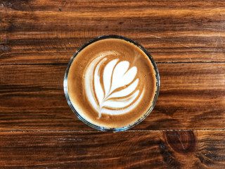 Cup of love , heart latte art coffee in Glass on the vintage wooden table. Love coffee love in your...