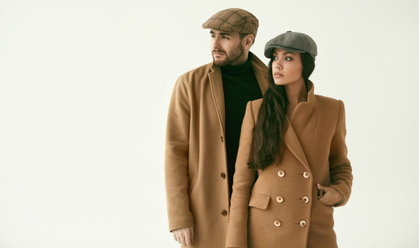 Portrait Of A Loving Couple Dressed In A Yellow Fashion Coat