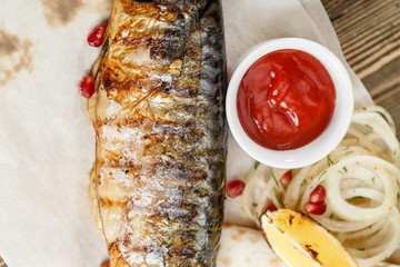 grilled mackerel. Serving on a wooden Board on a rustic table. Barbecue restaurant menu, a series of photos of different meats anf fish