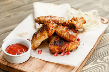 chicken wings grill. Serving on a wooden Board on a rustic table. Barbecue restaurant menu, a series of photos of different meats