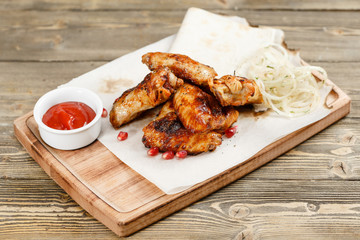 chicken wings grill. Serving on a wooden Board on a rustic table. Barbecue restaurant menu, a series of photos of different meats