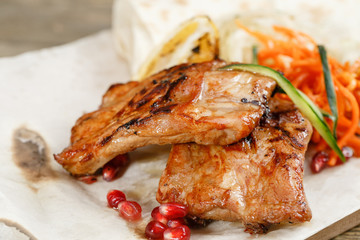 Grilled pork ribs. Serving on a wooden Board on a rustic table. Barbecue restaurant menu, a series of photos of different meats