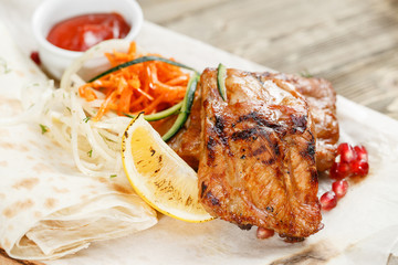 Grilled pork ribs. Serving on a wooden Board on a rustic table. Barbecue restaurant menu, a series of photos of different meats