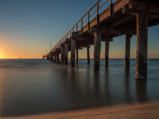 Long exposure of the sunset under Seaford Pier, Australia	